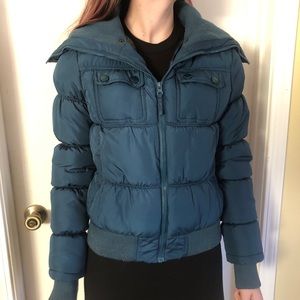 A turquoise puffer jacket
